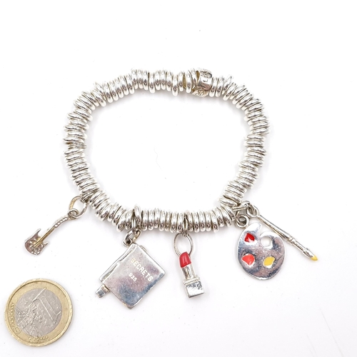 3 - A Links of London sterling silver bracelet set with four silver charms. Weight - 62.34 grams. Comes ... 