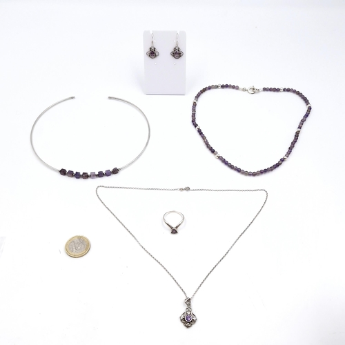 411 - A silver choker together with an amethyst bead necklace with silver clasp. Length - 42 cms. Also, a ... 