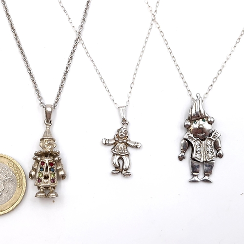 415 - Three sterling silver pendant necklaces each featuring clown motifs. Length of chains - 2 x 44 cms, ... 