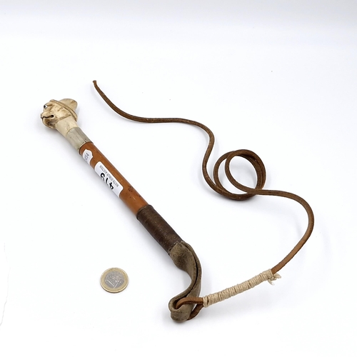 419 - An antique possibly a hunting whip set with pug faced dog with jewelled eyes with silver mount and l... 