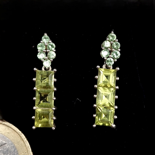 424 - An attractive pair of Peridot and Diopside stone drop stud earrings. Length - 2.5 cms. Boxed.