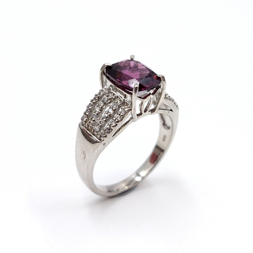 432 - A most attractive amethyst stone ring with four strand diamond mount. Est. weight of diamonds - 0.15... 