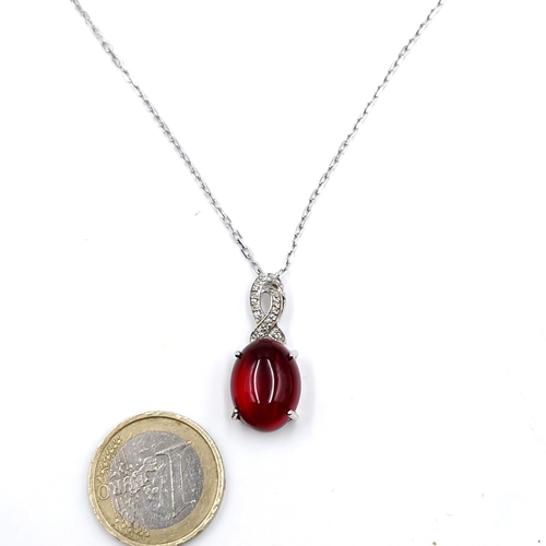 438 - A red cabochon gemstone drop pendant necklace set with sterling silver chain. Length - 46 cms. Boxed... 