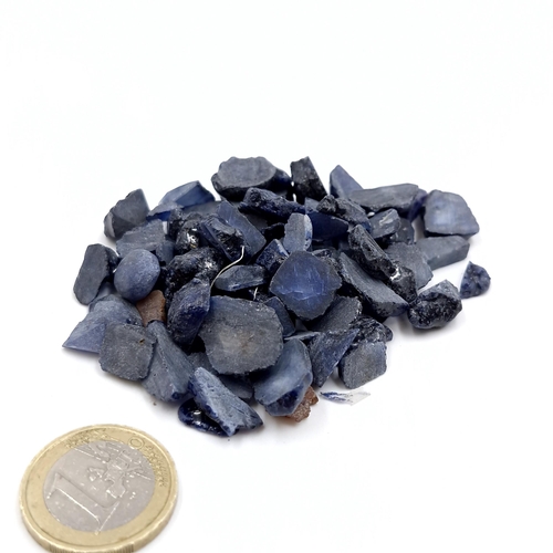 443 - A collection of rough cut blue sapphire gemstones of 384.7 carats.