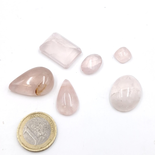 445 - An assortment of cabochon & facet cut rose quartz stones of 144.10 carats.