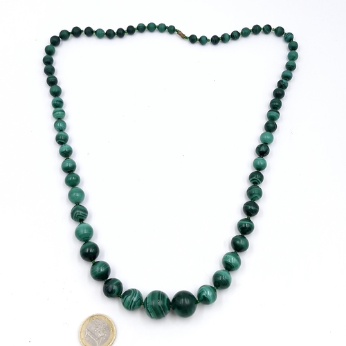 45 - A very good example of heavy malachite graduated gemstone necklace with twist clasp. Length - 66 cms... 