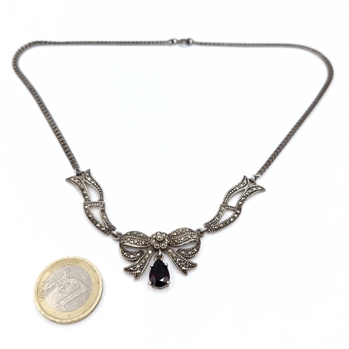 486 - A marcasite and onyx stone pendant & silver chain. Length - 38 cms. Total weight - 16.32 grams.