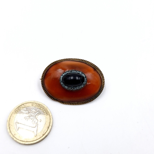 491 - A Victorian multi hard stone cabochon  brooch. Dimensions: 3.5 x 2.5 cms. Weight - 14.37 grams. Pin ... 