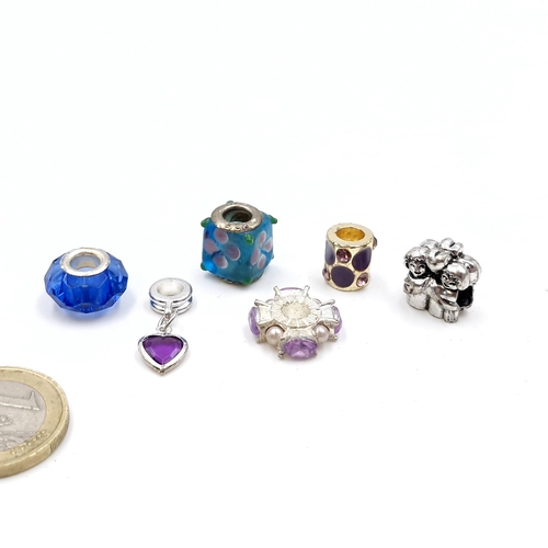 7 - A collection of six charms (one silver). Total weight - 19.30 grams.