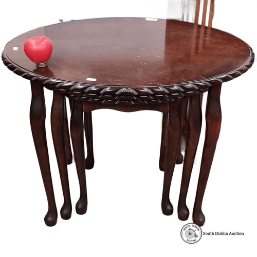 653 - Three-piece nested tables set in dark polished mahogany, featuring carved edges and classic cabriole... 