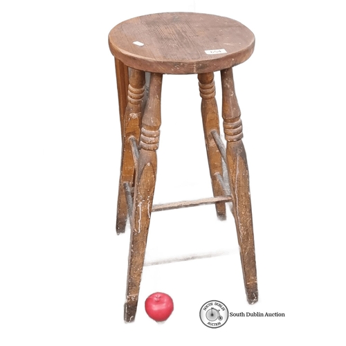 654 - Rustic wooden stool with turned legs and circular seat. Solid construction with natural wood grain f... 