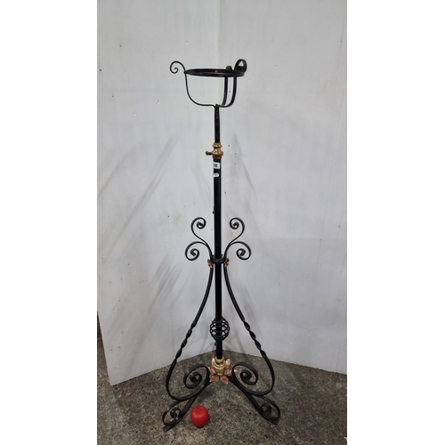 656 - Victorian wrought iron adjustable plant stand features brass valve detail and ornate scrollwork base... 