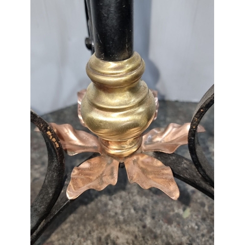 656 - Victorian wrought iron adjustable plant stand features brass valve detail and ornate scrollwork base... 