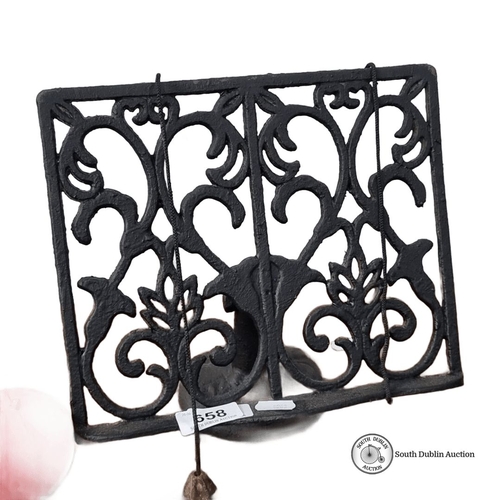 658 - Ornate cast iron book stand with intricate Victorian-style scrollwork.