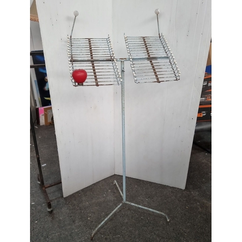 663 - A Vintage wire and metal rotating display stand with dual racks and tripod base. From a shop that cl... 