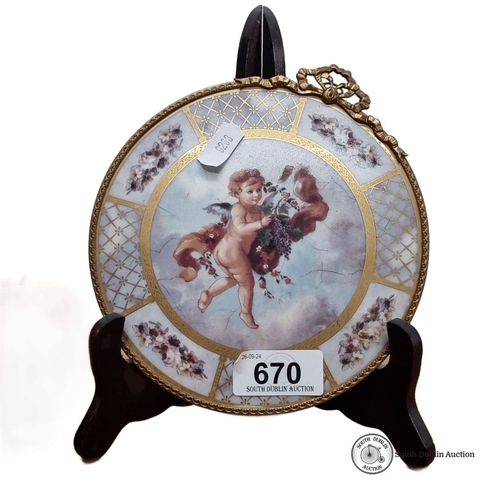 670 - A beautiful Limoges porcelain plate features a cherub motif, accented with gilt details and floral p... 