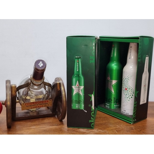 675 - An empyt Courvoisier Cognac bottle in a wooden cannon decanter holder. Accompanied by a boxed set of... 