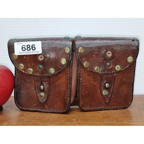 686 - Antique leather double pouch with brass rivet details and dual belt loops. From the early 20th centu... 