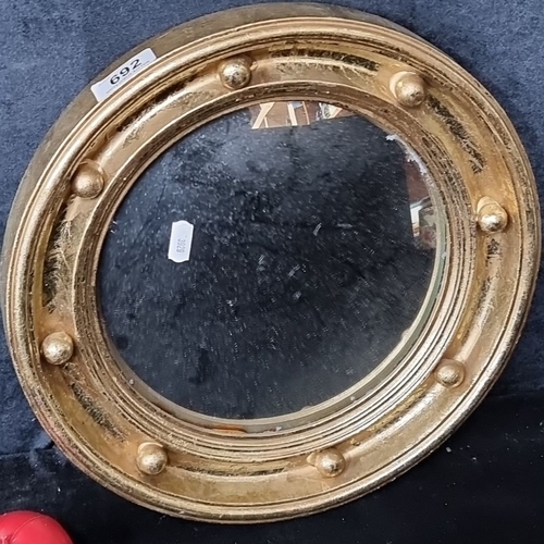 692 - Giltwood convex mirror in Georgian style has a circular frame adorned with ball decoration and beade... 