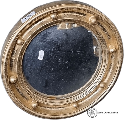 692 - Giltwood convex mirror in Georgian style has a circular frame adorned with ball decoration and beade... 