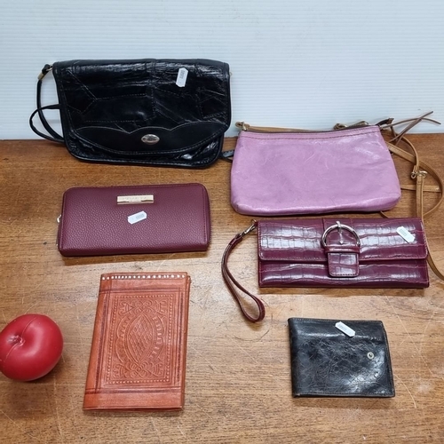 693 - Mixed lot comprising seven items: three leather wallets, one embossed leather notebook, one purple l... 