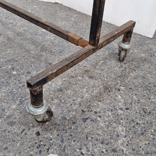 898 - Vintage commercial metal garment rack on casters.