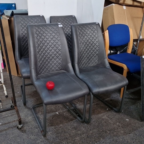 902 - A Set of four modern faux leather dining chairs with quilted backrest and cantilever metal base.