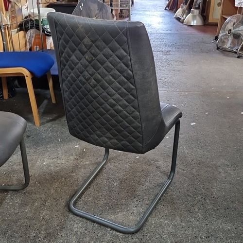 902 - A Set of four modern faux leather dining chairs with quilted backrest and cantilever metal base.