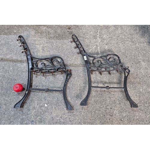 907 - Pair of vintage cast iron decorative bench legs with ornate scrollwork detailing.