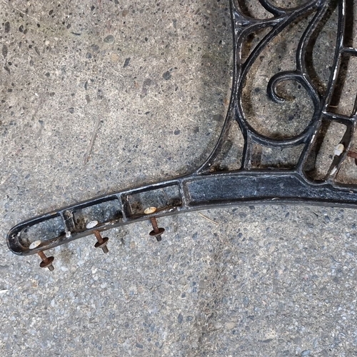 907 - Pair of vintage cast iron decorative bench legs with ornate scrollwork detailing.