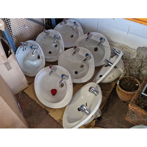 910 - Star lot: A Set of nine white Armitage Shanks ceramic sinks, each with dual hot and cold chrome taps... 