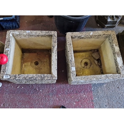 916 - A Pair of vintage stone planters with a rustic rock-faced design.