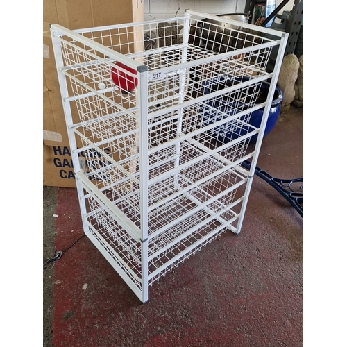 917 - A White metal storage rack with five wire mesh shelves.