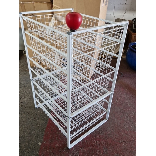 917 - A White metal storage rack with five wire mesh shelves.