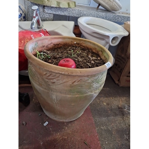 918 - A Large terracotta planter with raised leaf and geometric motifs.