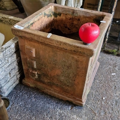 921 - A large Square terracotta garden planter with weathered patina, featuring four raised square decorat... 