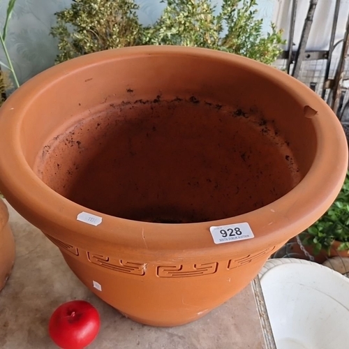 928 - A large Terracotta plant pot with Greek-key motif along the rim. It has a smooth, wide lip and a cla... 