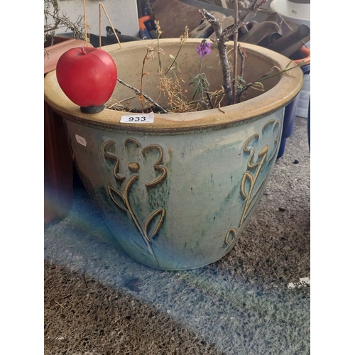 933 - Two ceramic planters, one adorned with an embossed floral design in a beige and green glaze and the ... 