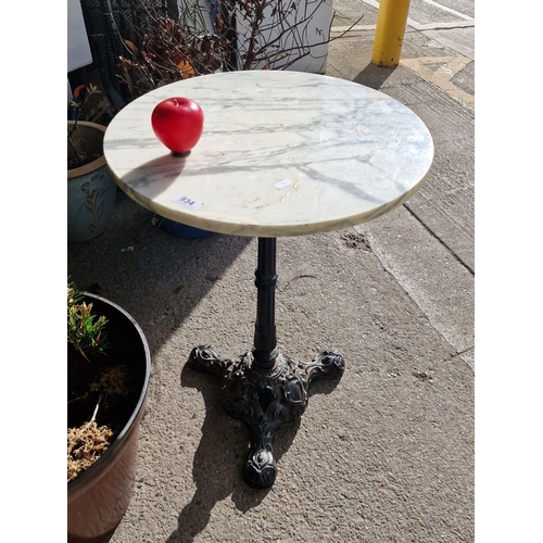 934 - Star lot : A Marble-topped table with ornate cast iron pedestal base.A good quality lot.