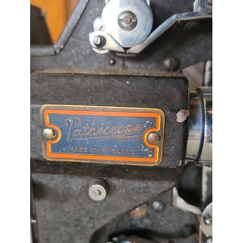 954 - Vintage Pathéscope 9.5mm film projector, made in England. Features detailed mechanics and classic de... 