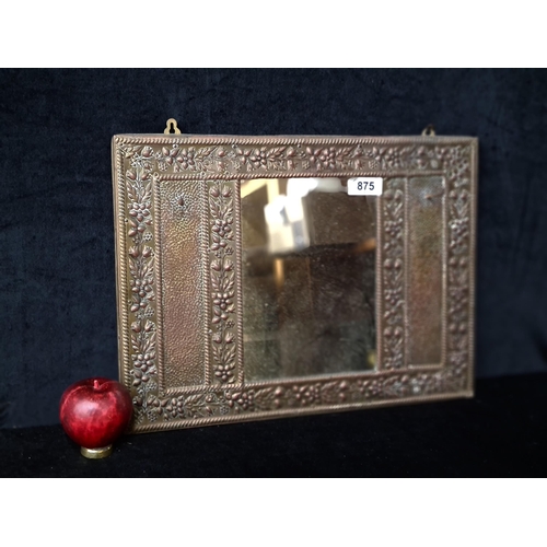 875 - A nice vintage wall mounting mirror with an ornate embossed copper frame with two hooks on either si... 