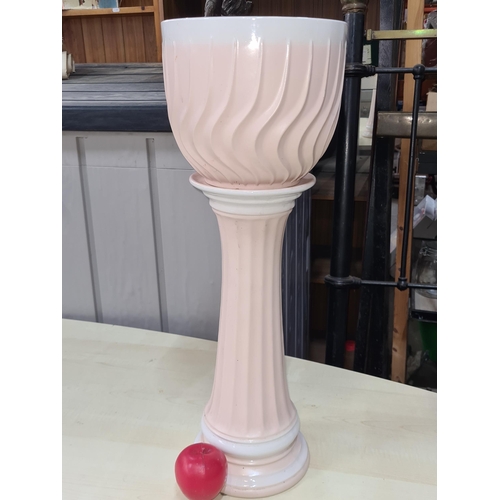 496 - A pretty Gardinere with a ribbed form and matching stand. Numbers stamped to base. In good condition... 