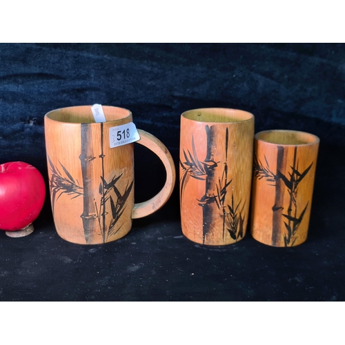 518 - Three vintage hand made and painted Japanese bamboo cups including a handled example.