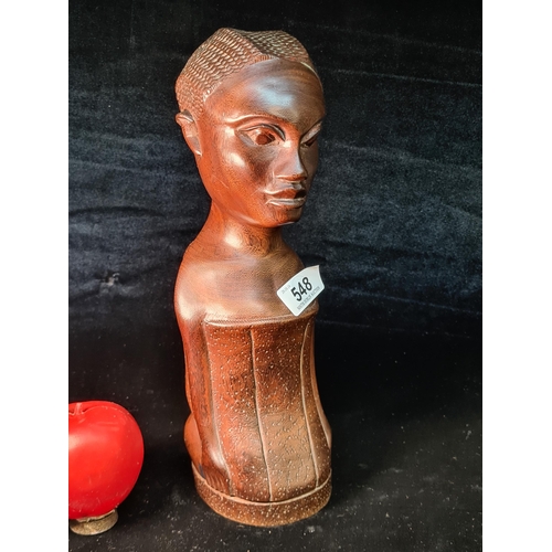 548 - An African carved wooden bust of a woman with a child sculpture. Features a calm pleasant face with ... 