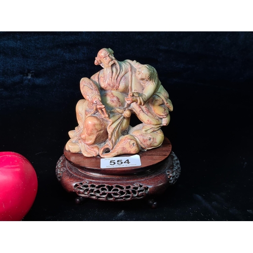 554 - An antique Chinese Soapstone Sculpture. Features seated Chinese figure portraying a narrative scene.... 