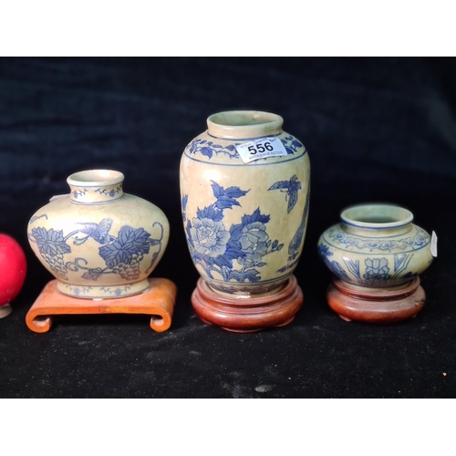 556 - Three Chinese Porcelain Storage Jar / Vases mounted on wooden bases. Features Blue and white floral ... 