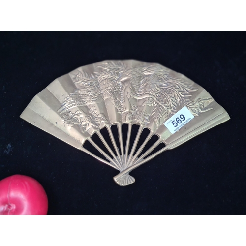 569 - A superb vintage Japanese brass fan which depicts the phoenix immortal sun bird in relief.