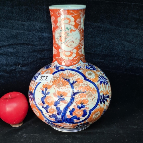 573 - A gorgeous Japanesse Imari tall bottle shaped vase. Hand painted in vibrant tones of orange and blue... 