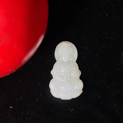 575 - A clean example of a jadeite pendant / amulet of a seated buddha. MM: 4cm. Would have been held in t... 