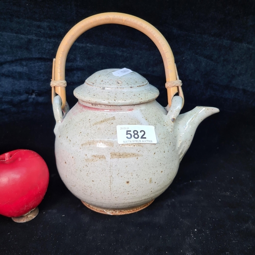 582 - A vintage ceramic Japanese style teapot featuring speckled detail to glaze and rattan handle.